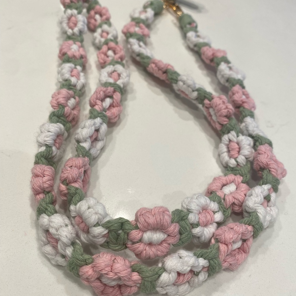 Embroidered daisy crossbody phone carrying chain.